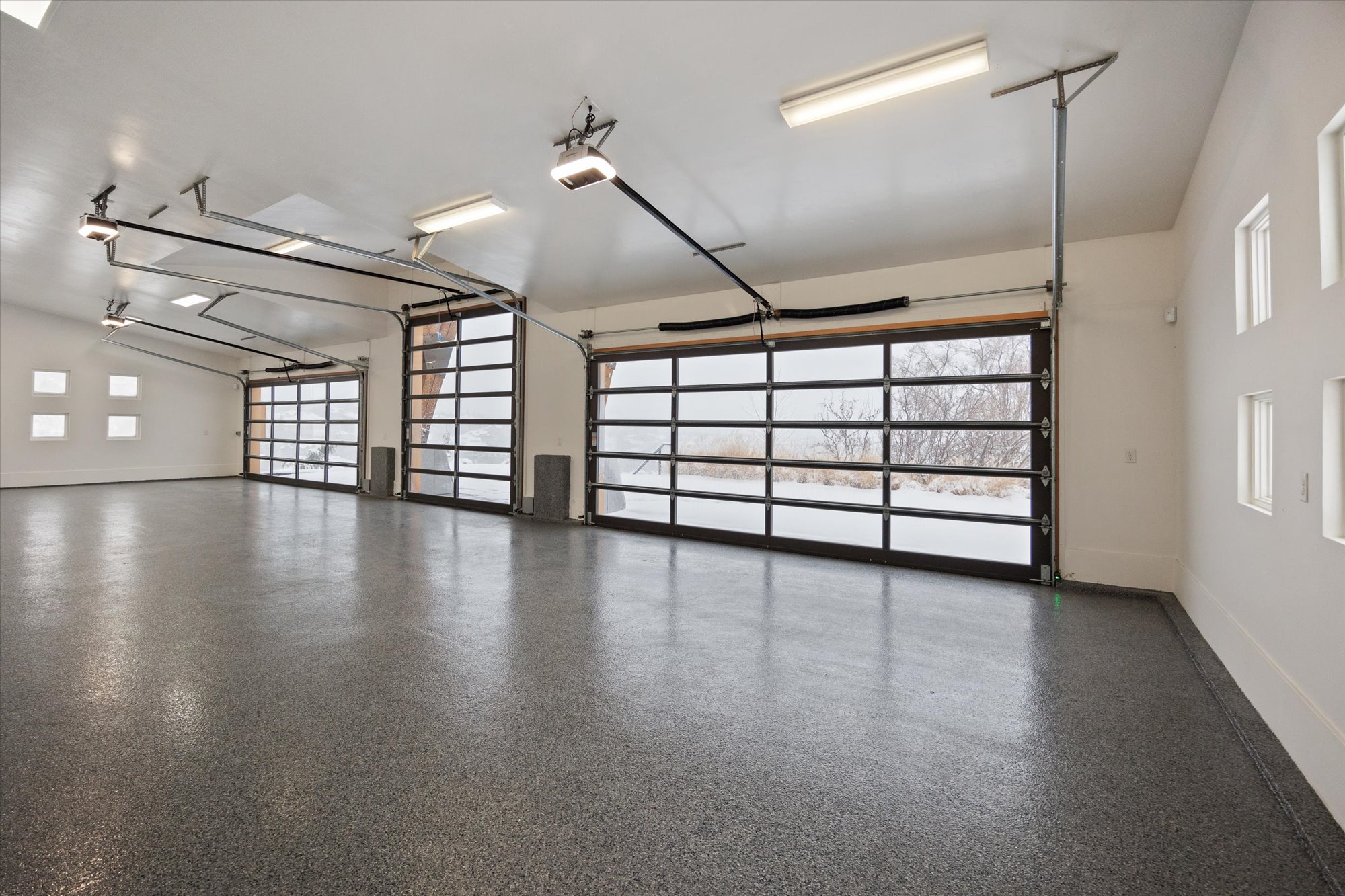 Garage with baseboards and a garage door opener