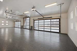 Garage with baseboards and a garage door opener