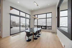 Dining area with a chandelier and light wood-style floors