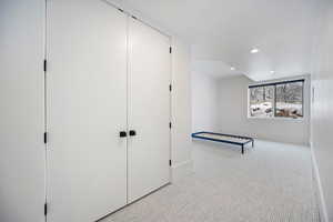 Unfurnished bedroom featuring light carpet, recessed lighting, and a closet