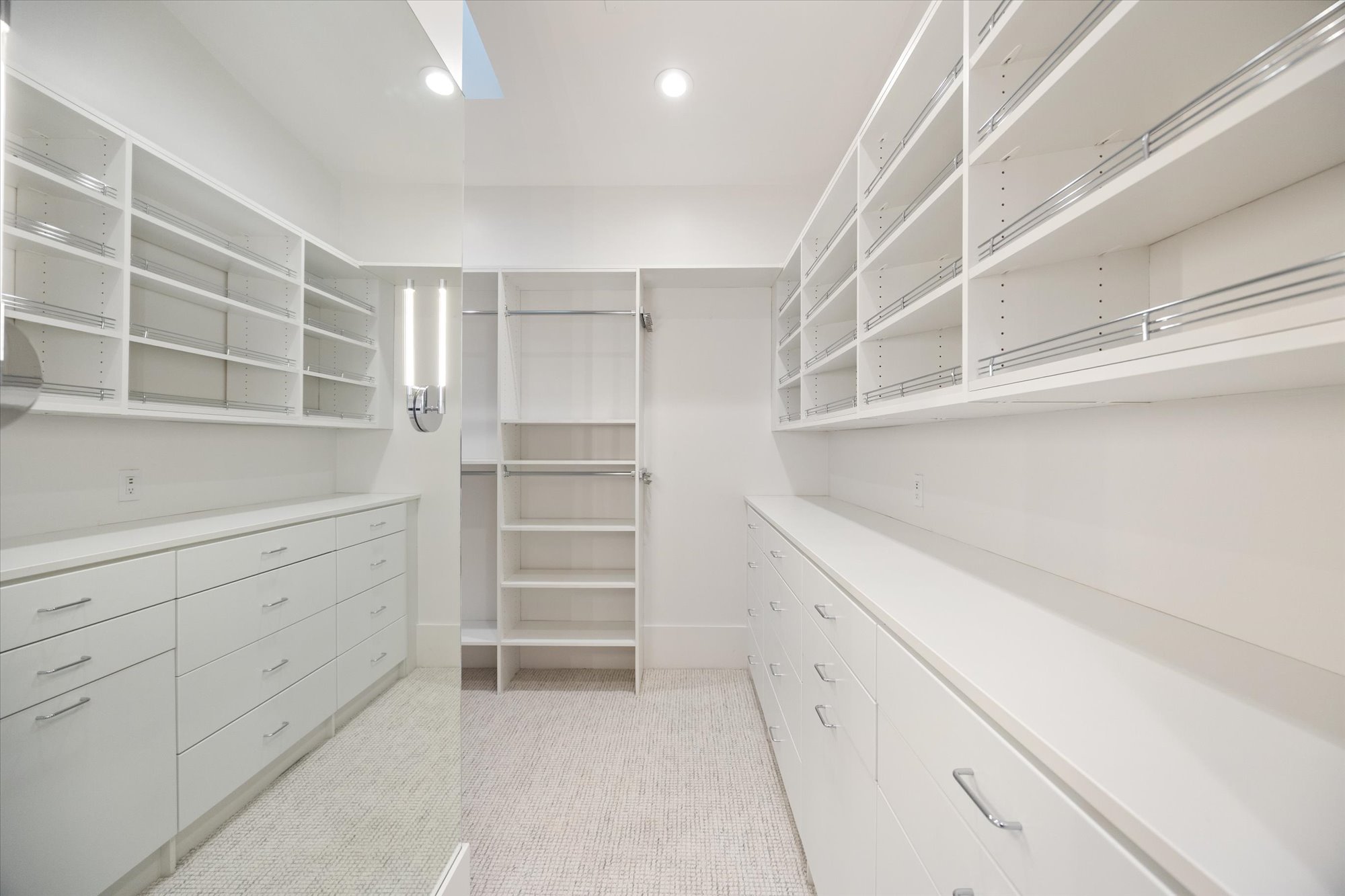 Walk in closet with light colored carpet