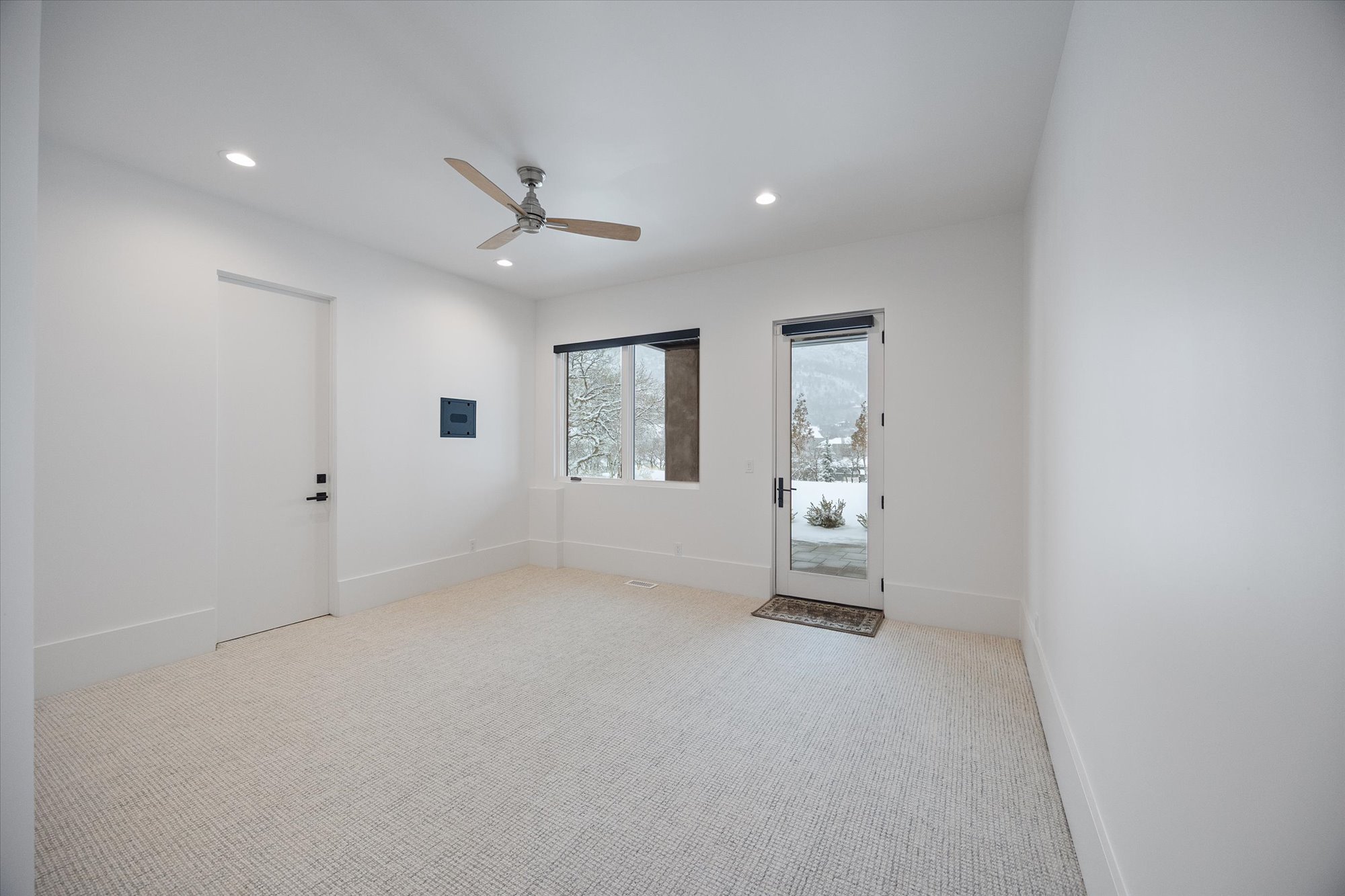 Empty room featuring light colored carpet, a ceiling fan, and recessed lighting