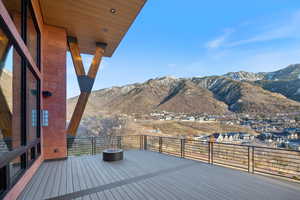 Deck with a mountain view and a residential view