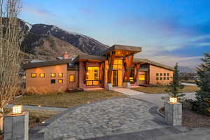 Contemporary house with a chimney, a mountain view, and a yard