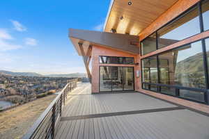 Wooden terrace featuring a mountain view and a residential view