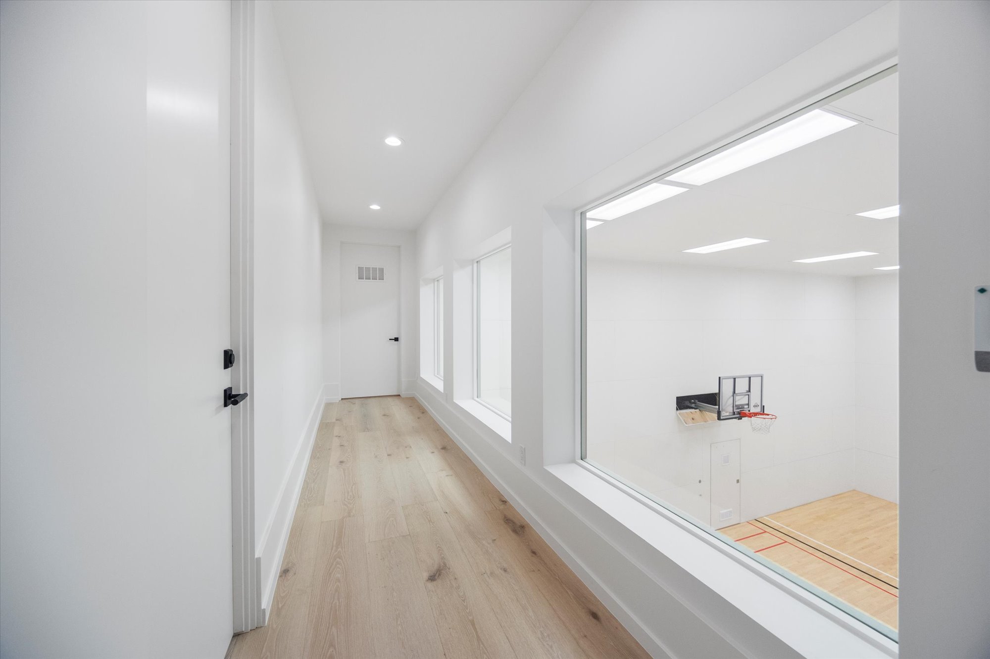 Hall featuring light wood-type flooring and recessed lighting