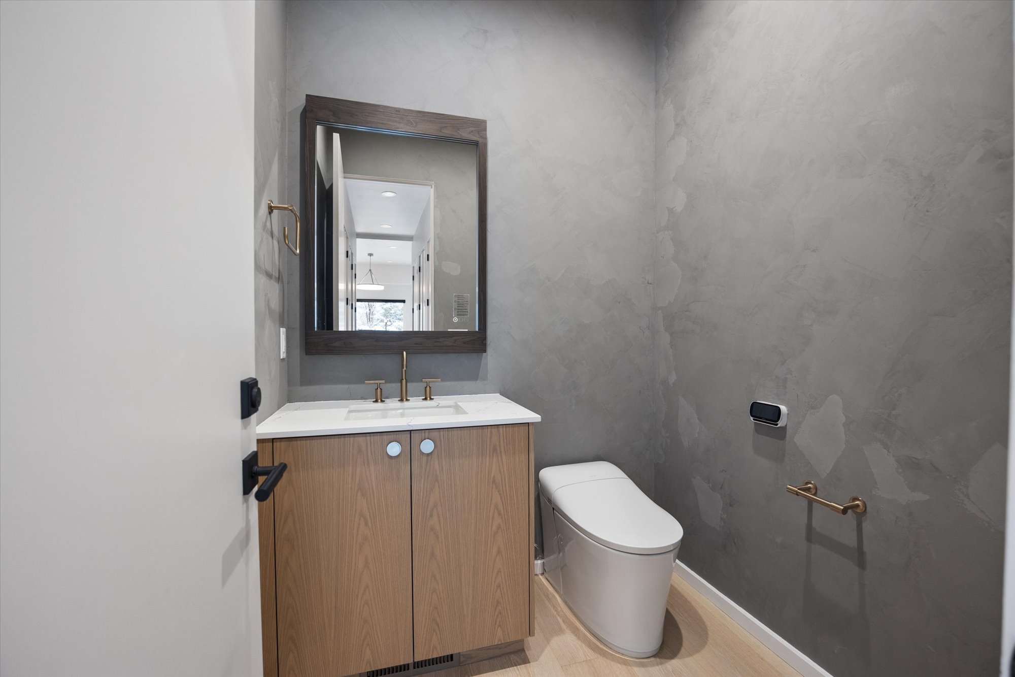 Half bath featuring vanity and toilet