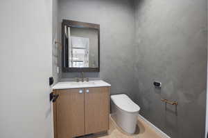 Half bath featuring vanity and toilet