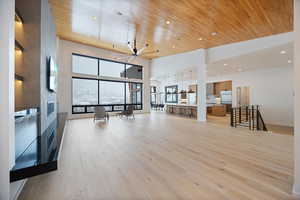Living room featuring light wood-style flooring, a high wood ceiling, recessed lighting, and ceiling fan