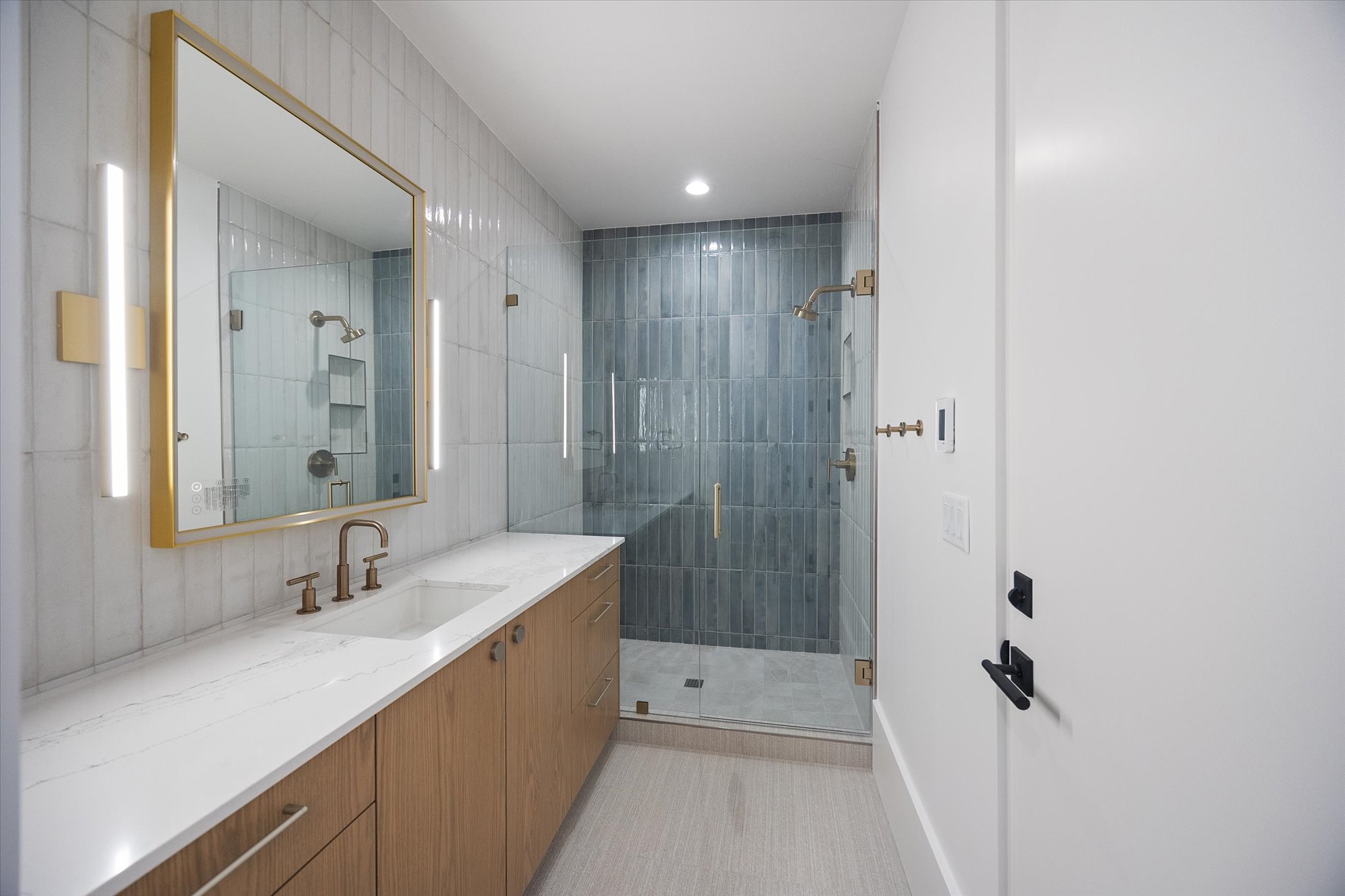 Full bathroom featuring vanity, a stall shower, recessed lighting, and tile walls