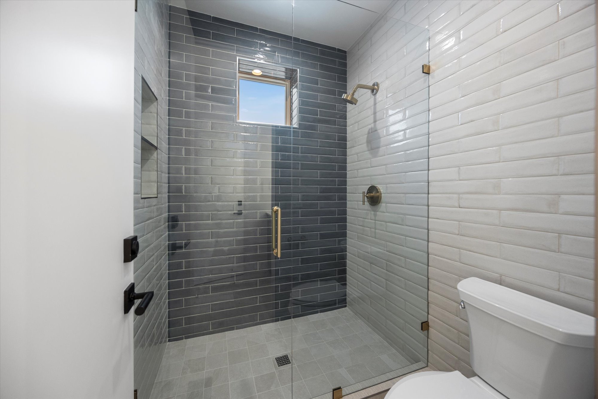 Full bathroom featuring toilet and a stall shower