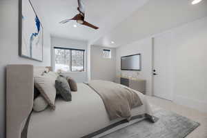 Carpeted bedroom with a ceiling fan and recessed lighting