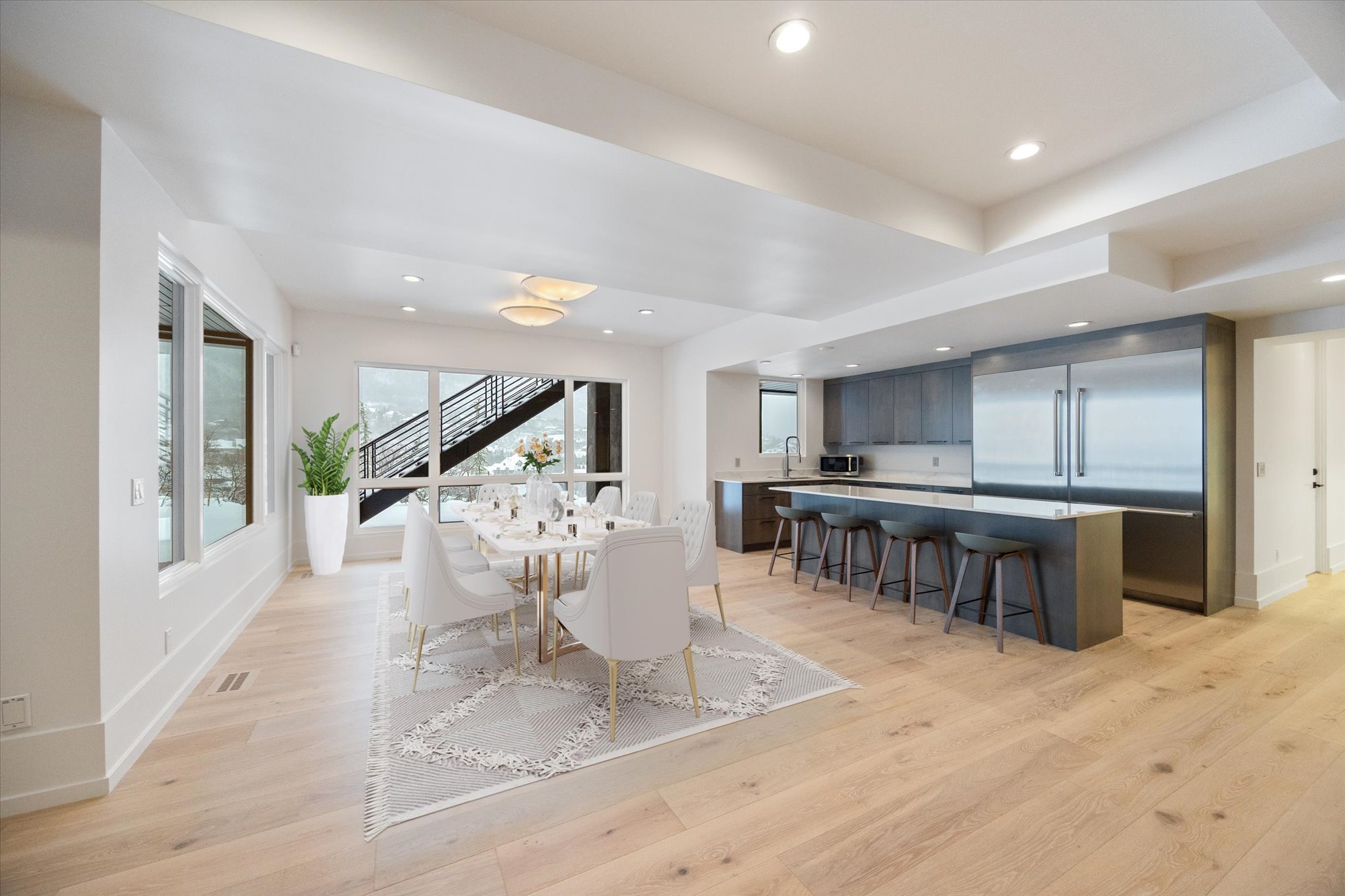 Dining area with light wood-type flooring and recessed lighting