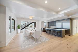 Dining area with light wood-type flooring and recessed lighting