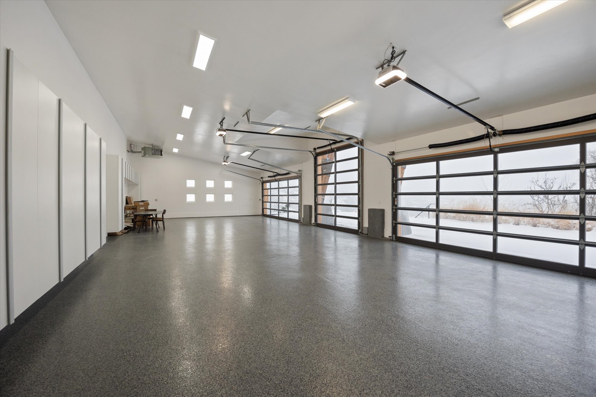 Garage featuring a garage door opener and a heating unit