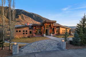 Contemporary house featuring a mountain view, a standing seam roof, and a chimney