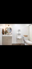 Bathroom with vanity and dark wood-type flooring