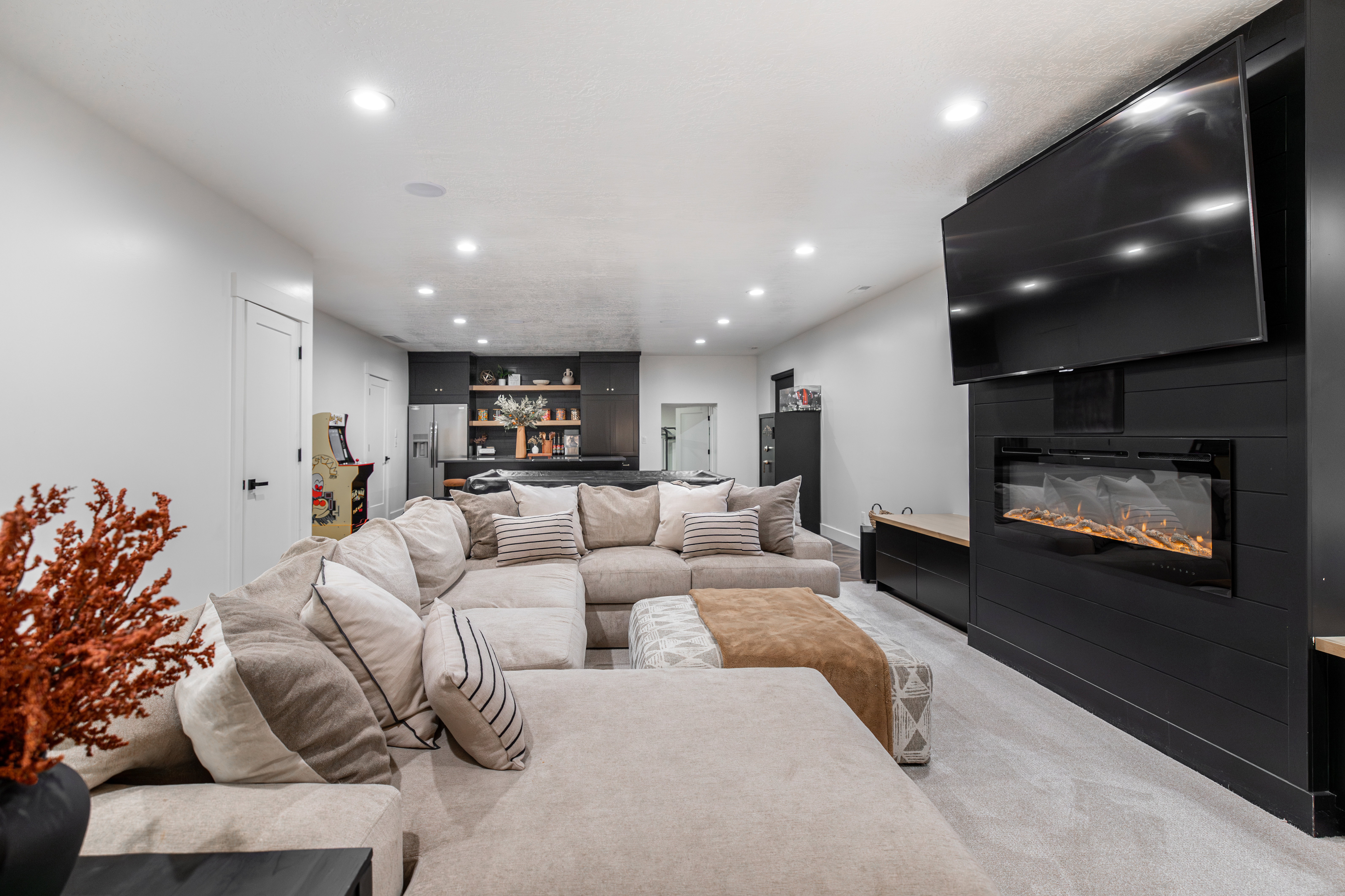 Living room featuring light colored carpet, recessed lighting, a fireplace, and bar