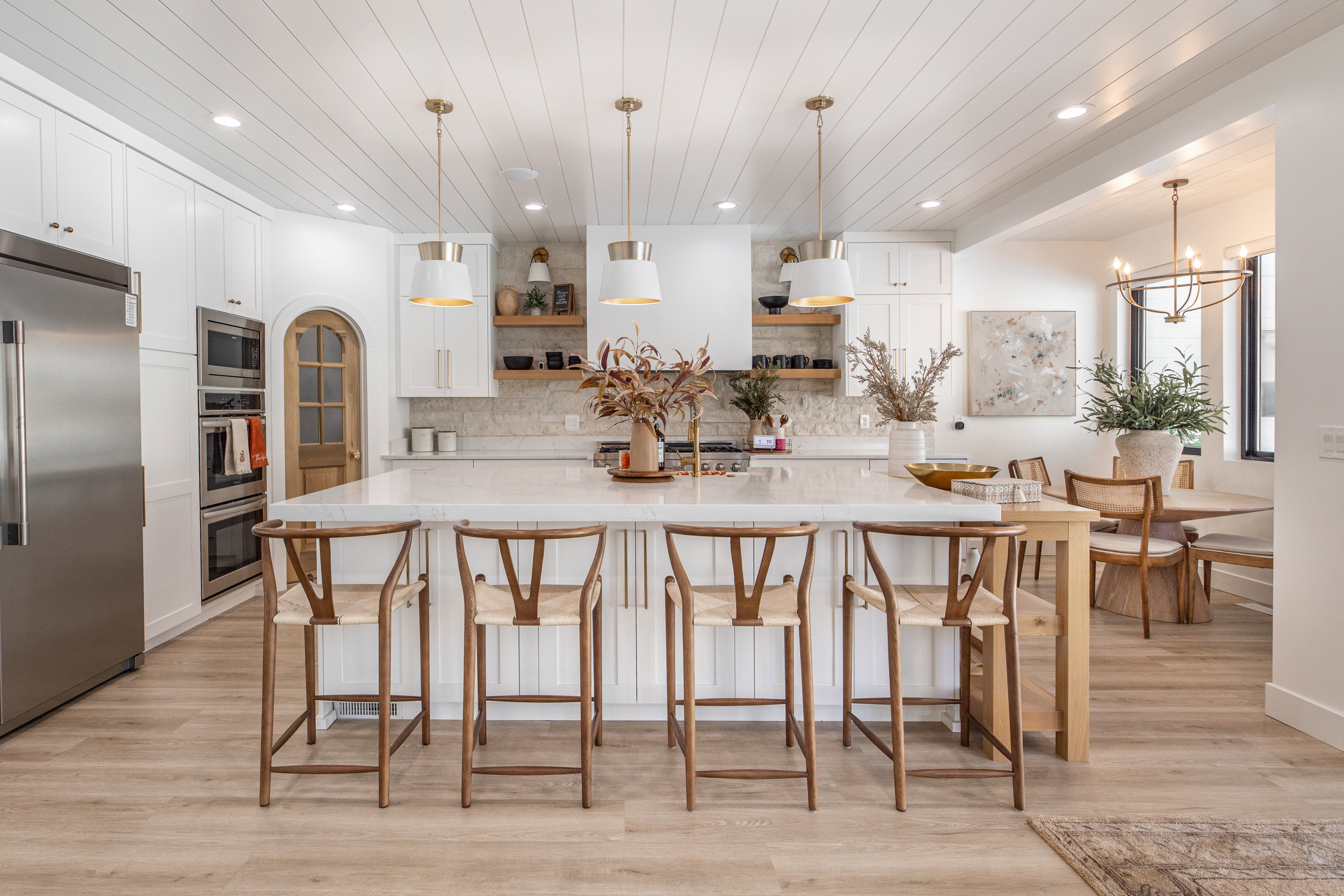 Kitchen featuring open shelves, white cabinets, stainless steel appliances, light wood finished floors, and wood ceiling