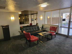 Living area featuring a textured ceiling and baseboards