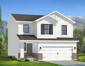 View of front facade featuring brick siding, a mountain view, an attached garage, and driveway