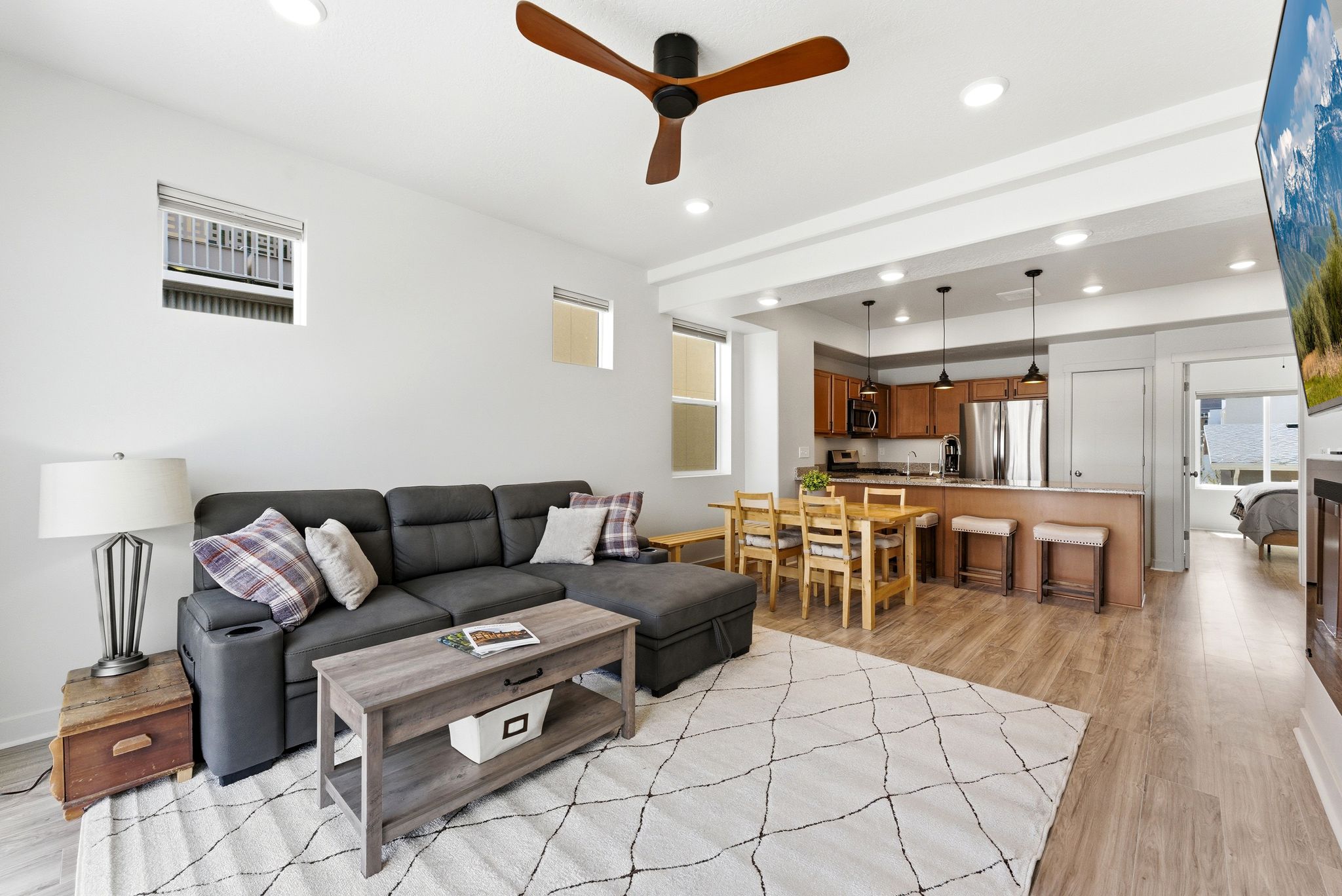 Living room with ceiling fan, light wood-type flooring, and recessed lighting