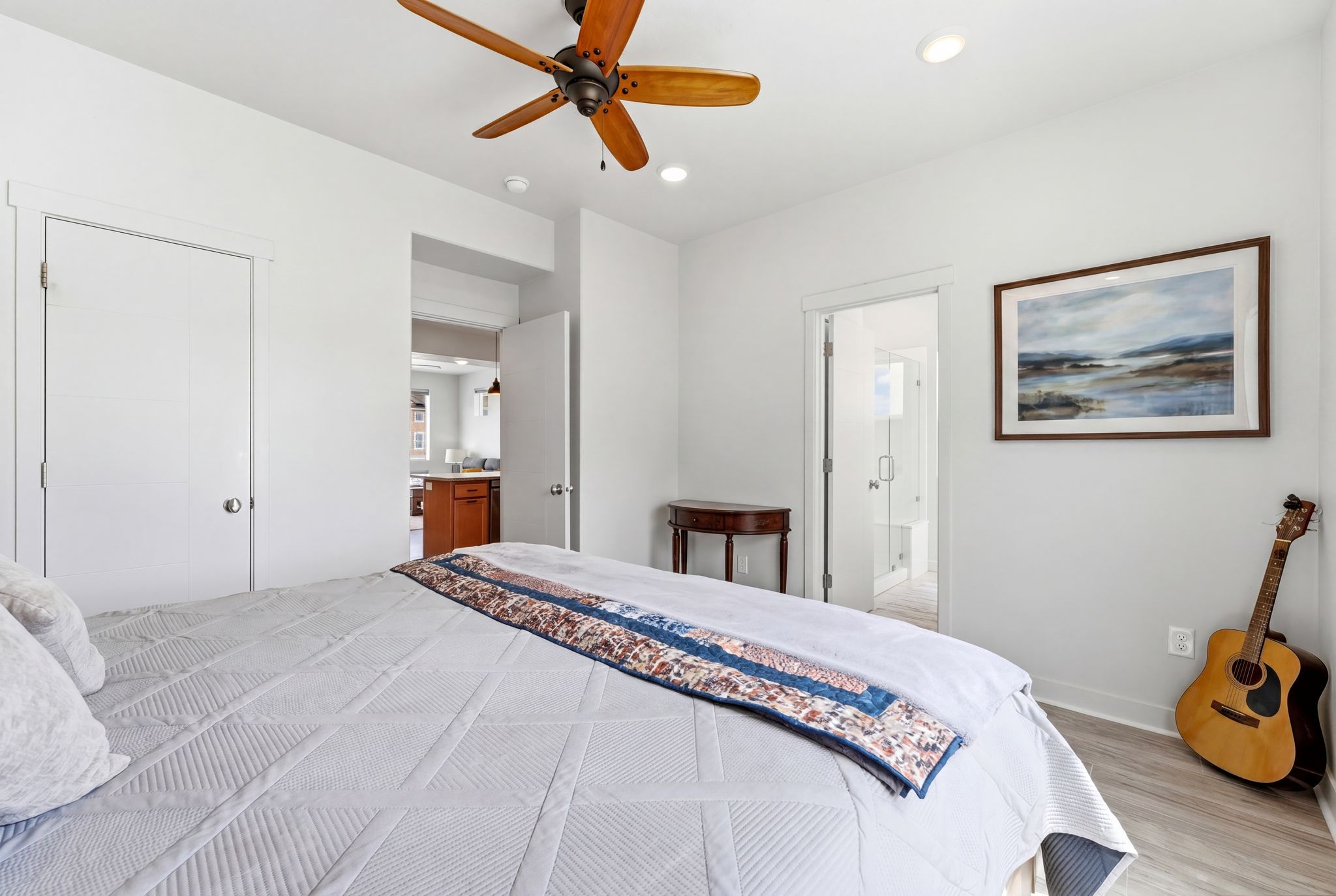 Bedroom featuring light wood finished floors, connected bathroom, ceiling fan, and recessed lighting