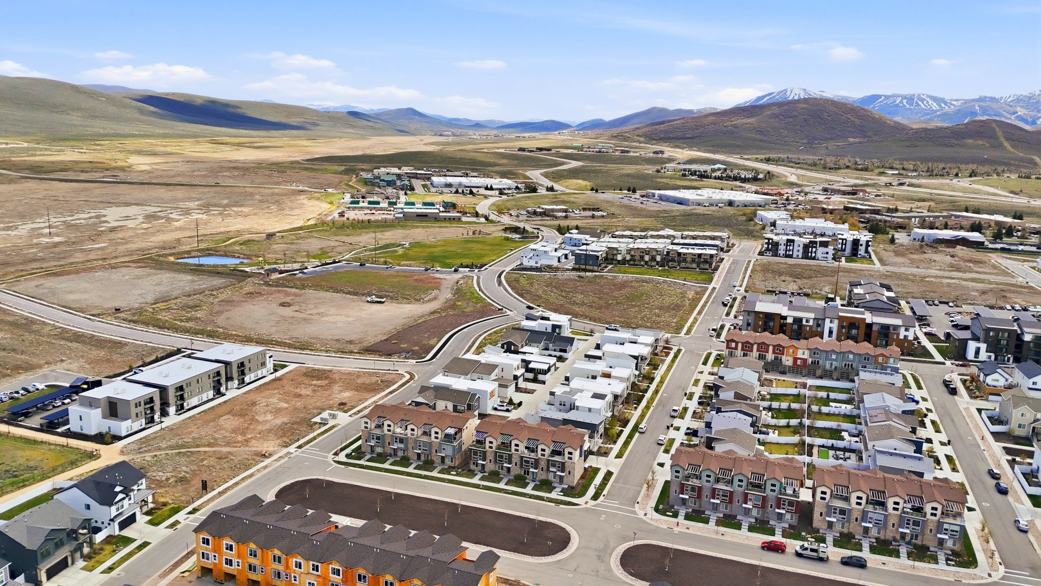 Aerial overview of property's location with a mountain backdrop and nearby suburban area