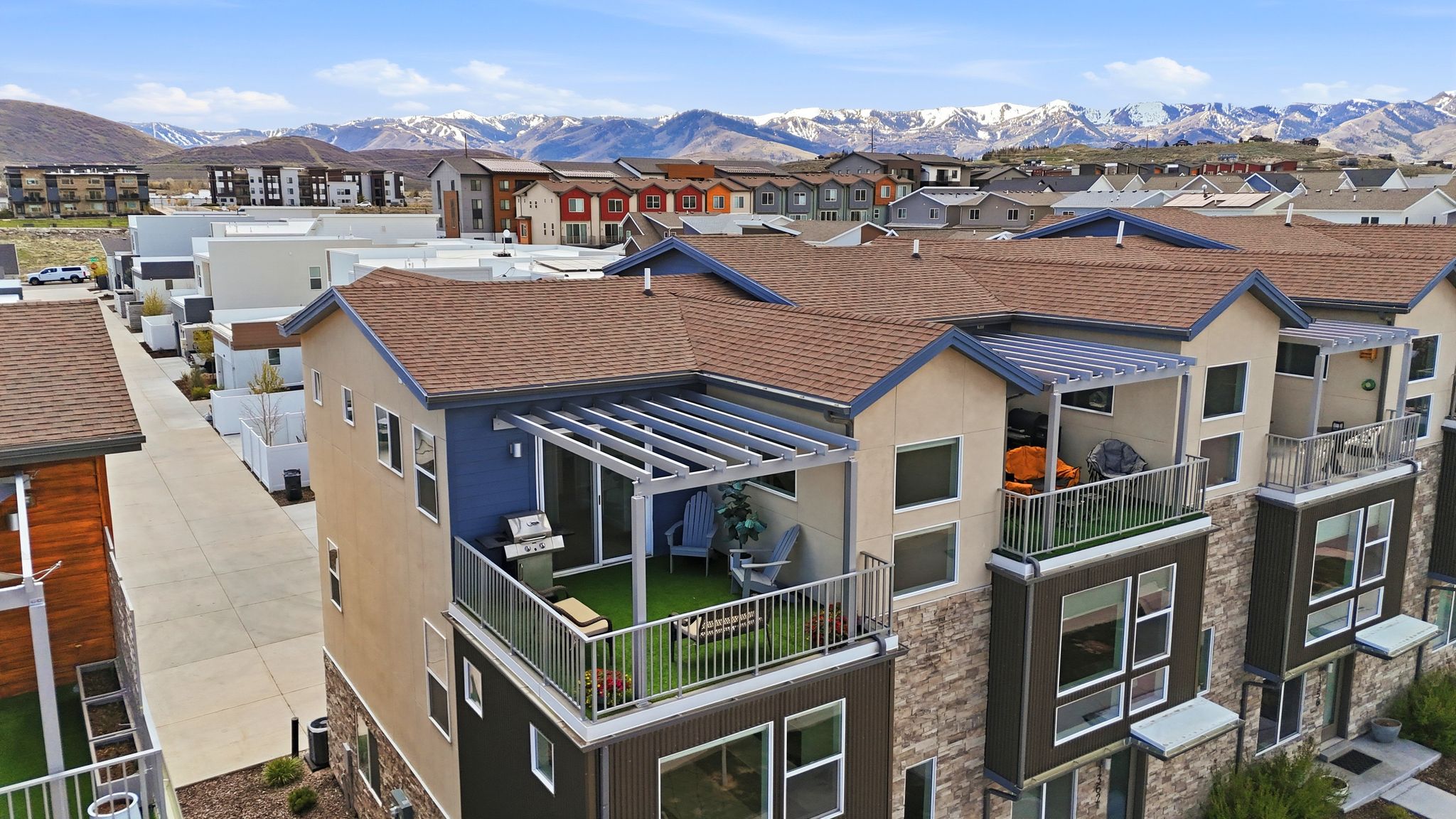 Aerial perspective of suburban area featuring a mountainous background