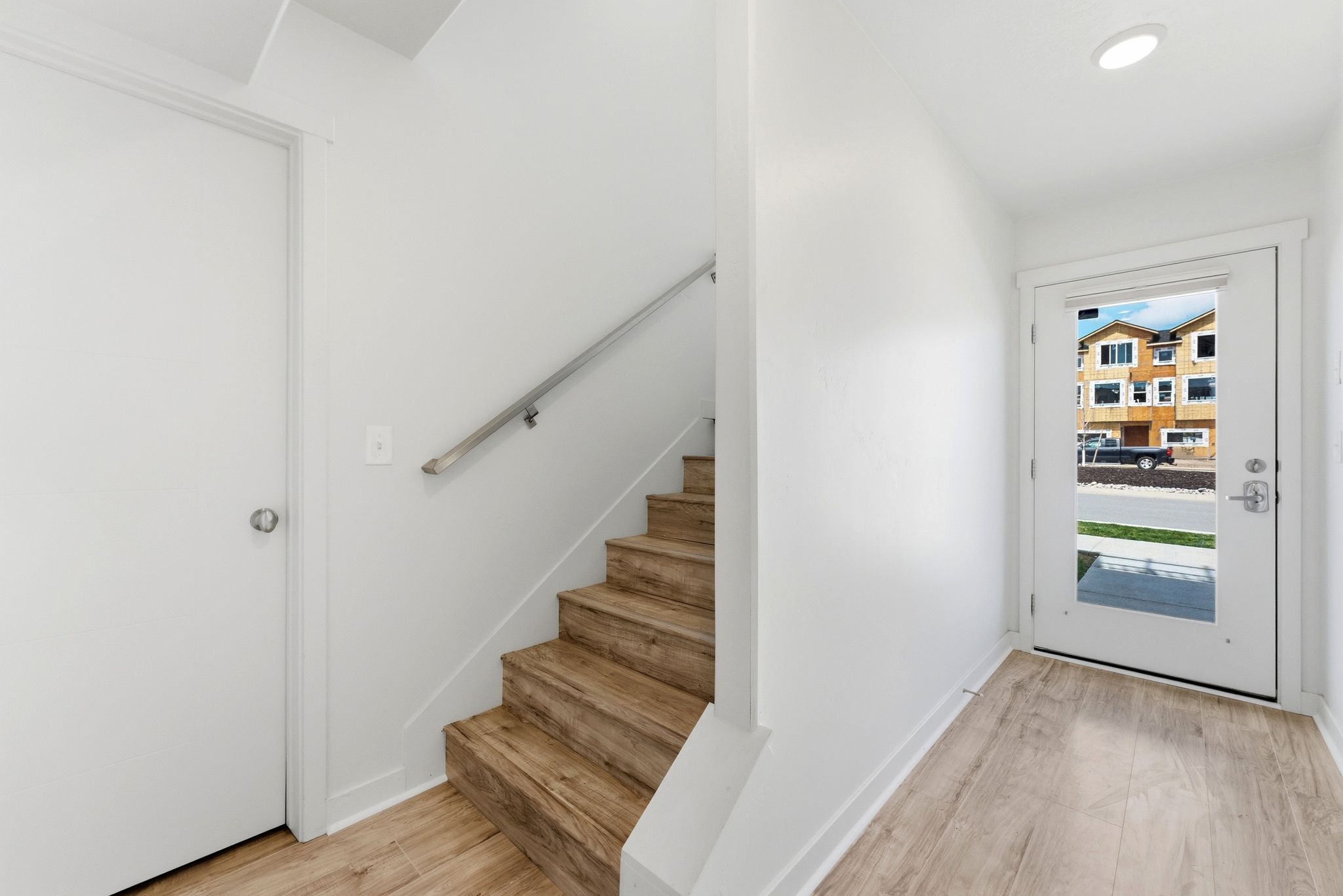 Foyer with stairway and light wood finished floors