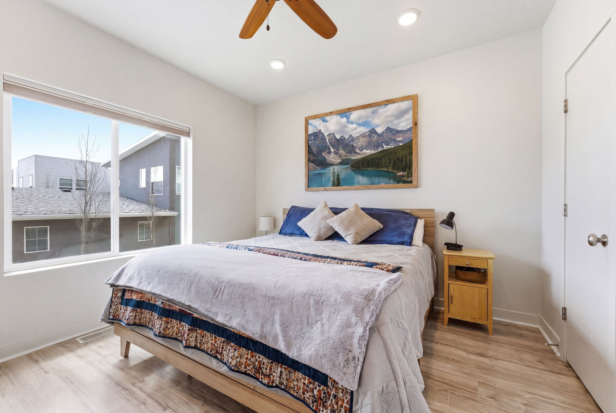 Bedroom featuring light wood-style floors, ceiling fan, and recessed lighting