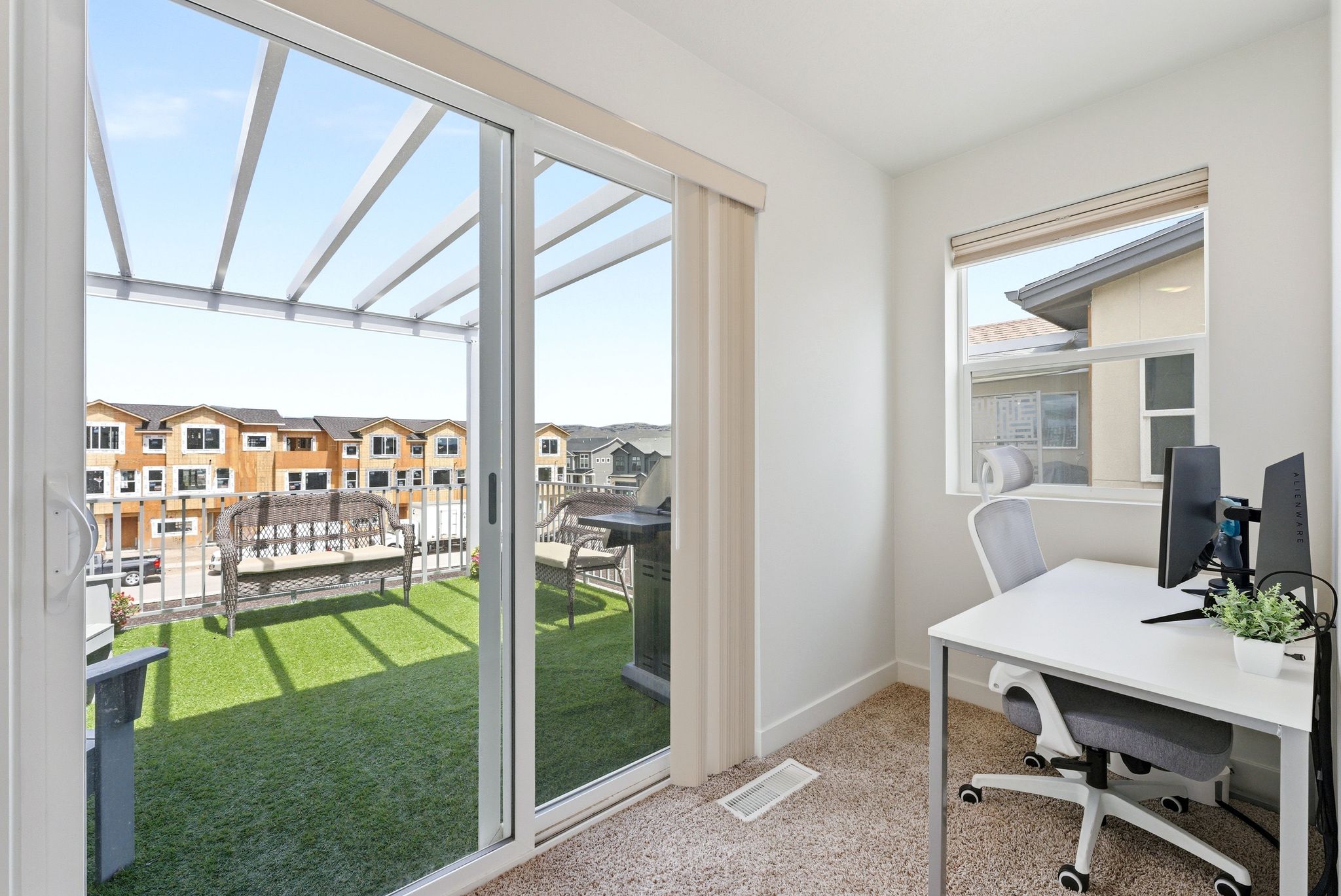 Home office featuring light colored carpet and a residential view
