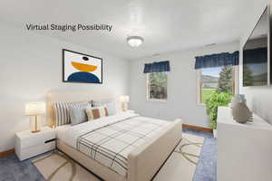 Bedroom featuring carpet floors and a textured ceiling