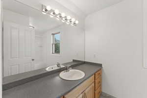 Bathroom featuring vanity and a shower