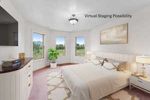 Bedroom featuring light colored carpet and a textured ceiling