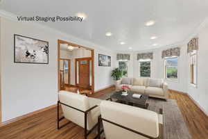 Living room featuring ornamental molding and wood finished floors