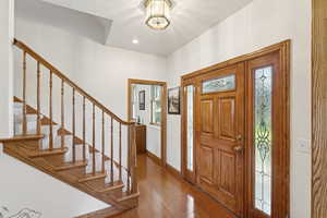 Foyer with a textured ceiling and wood finished floors
