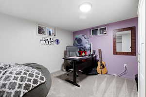 Bedroom featuring light colored carpet and baseboards