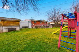 Fenced backyard with a playground, a patio area, and an outdoor living space