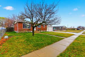 Ranch-style house featuring brick siding, driveway, and a garage