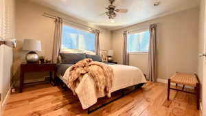 Bedroom with light wood-style flooring, ceiling fan, and recessed lighting