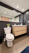 Bathroom featuring vanity, dark tile patterned floors, and recessed lighting