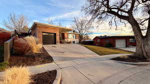 Single story home with brick siding, concrete driveway, and a garage