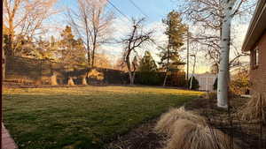 Fenced backyard with a storage shed