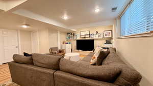 Living room featuring a textured ceiling and wood finished floors