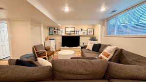 Living room featuring a textured ceiling and wood finished floors