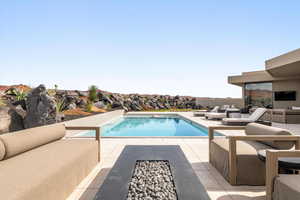 Swimming pool featuring an outdoor living space and a patio