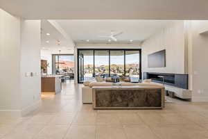 Living area featuring plenty of natural light, ceiling fan, and recessed lighting