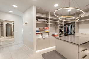 Walk in closet featuring light tile patterned floors