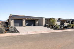 Modern home with stucco siding, driveway, and a garage